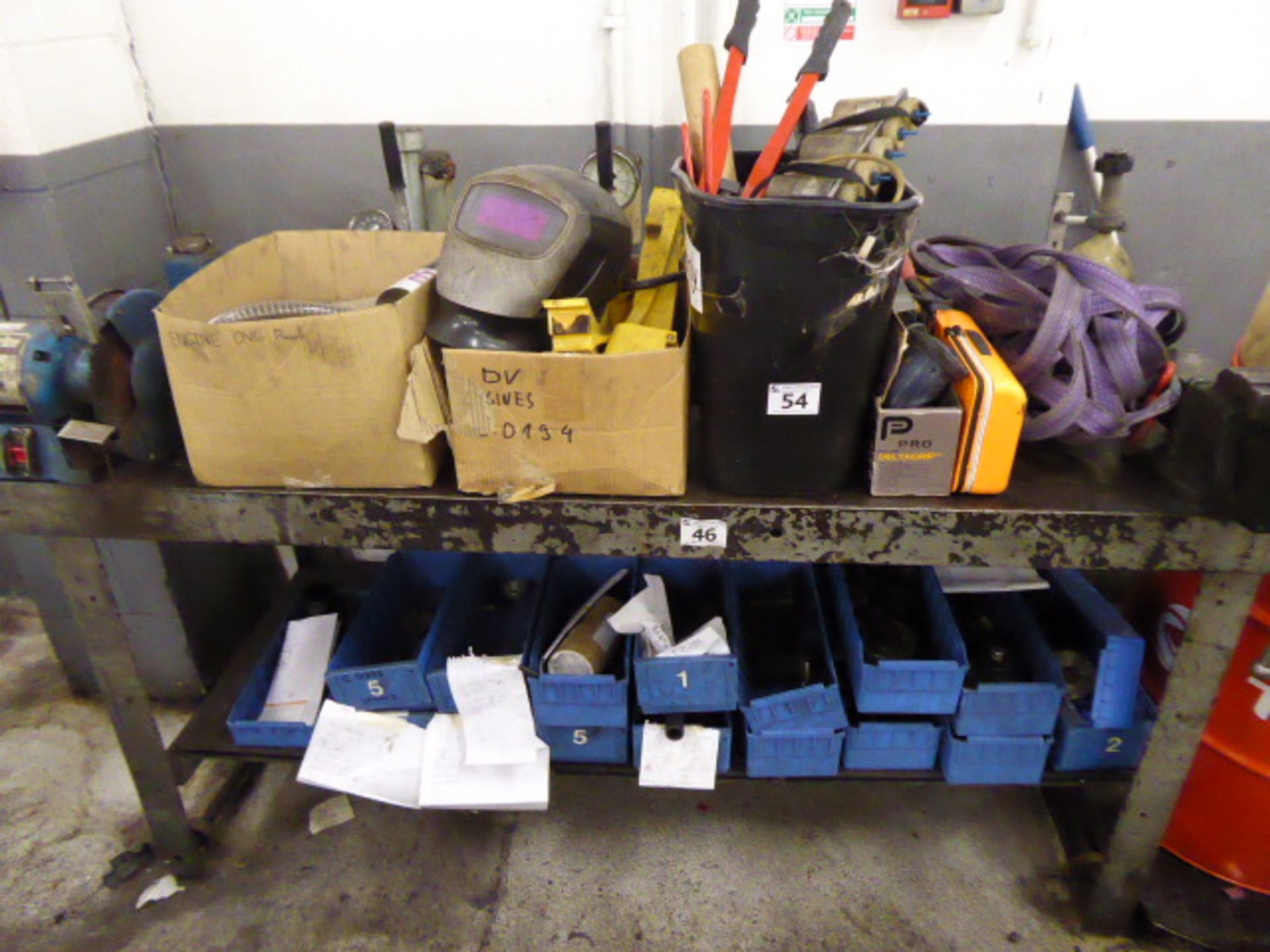 Contents of bench including welding mask, large riveter, angle grinder, etc