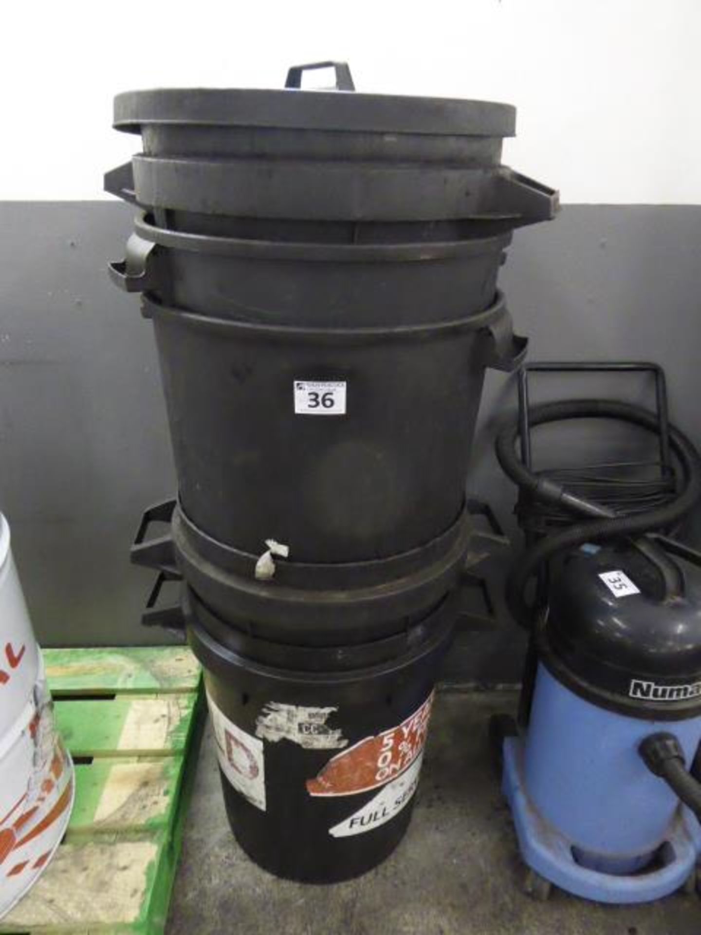 A stack of black plastic bins