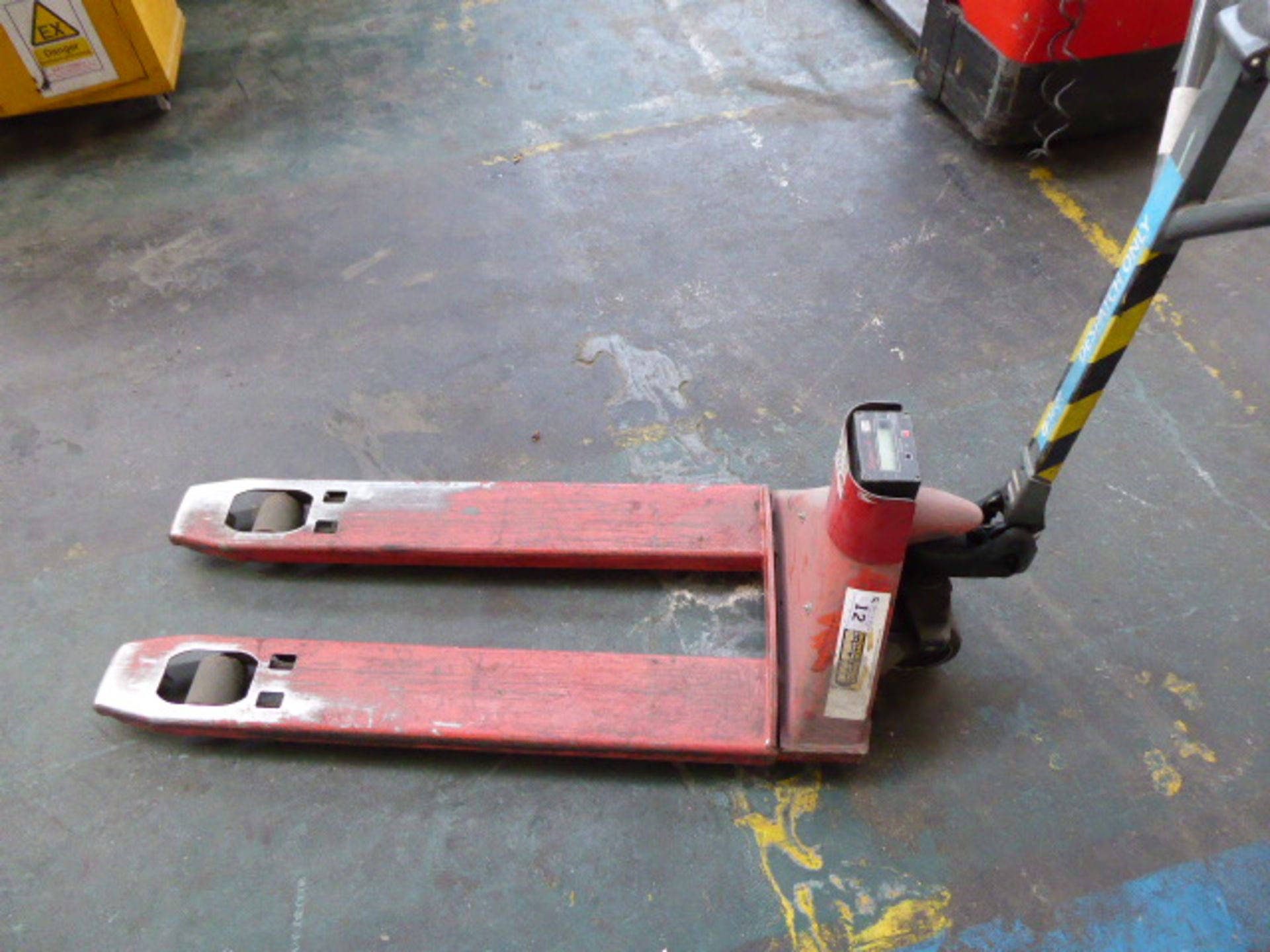 Red pallet truck with a Sigma 2 digital scale set