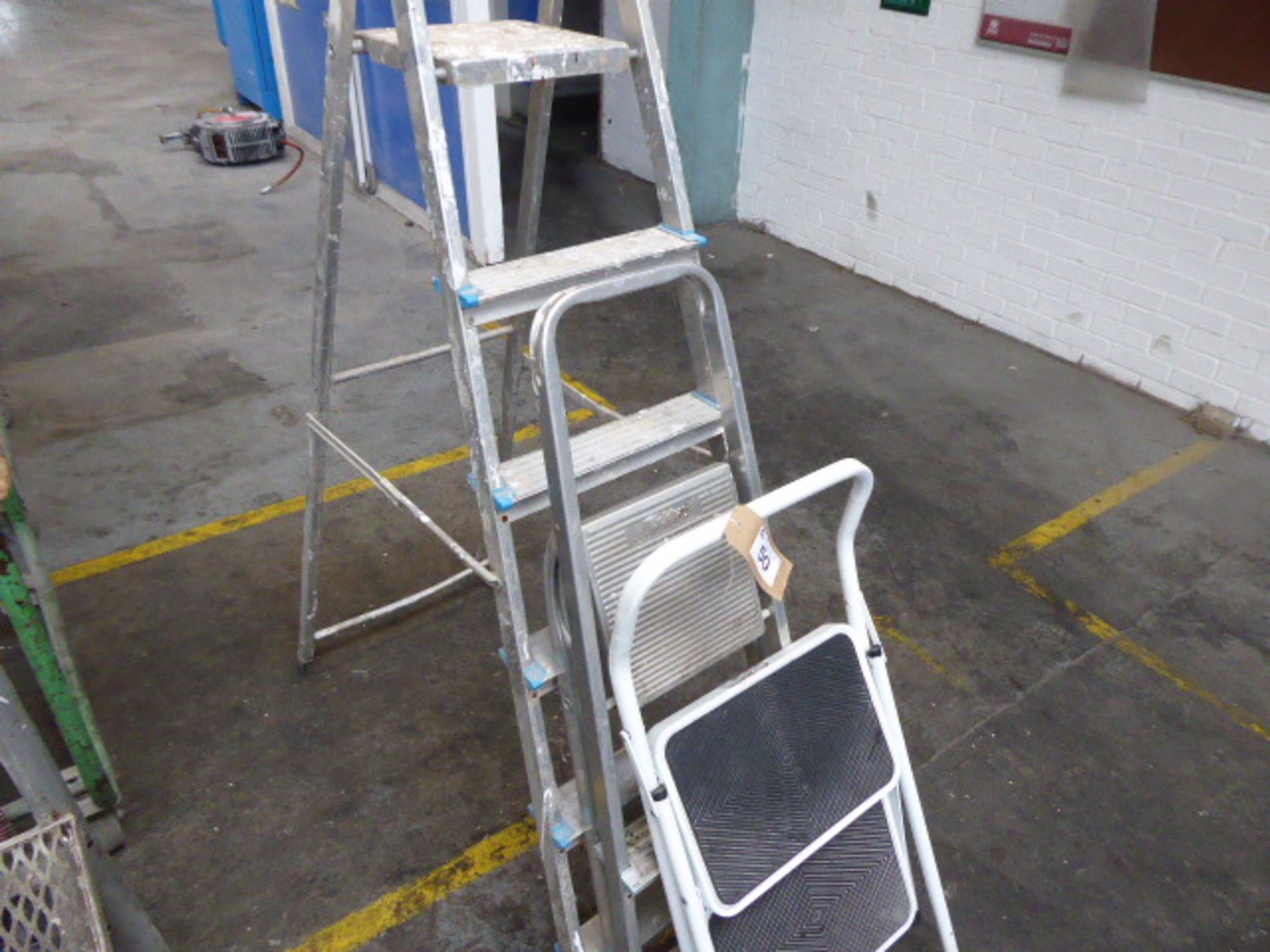 2 aluminum step ladders and 1 other white step ladder
