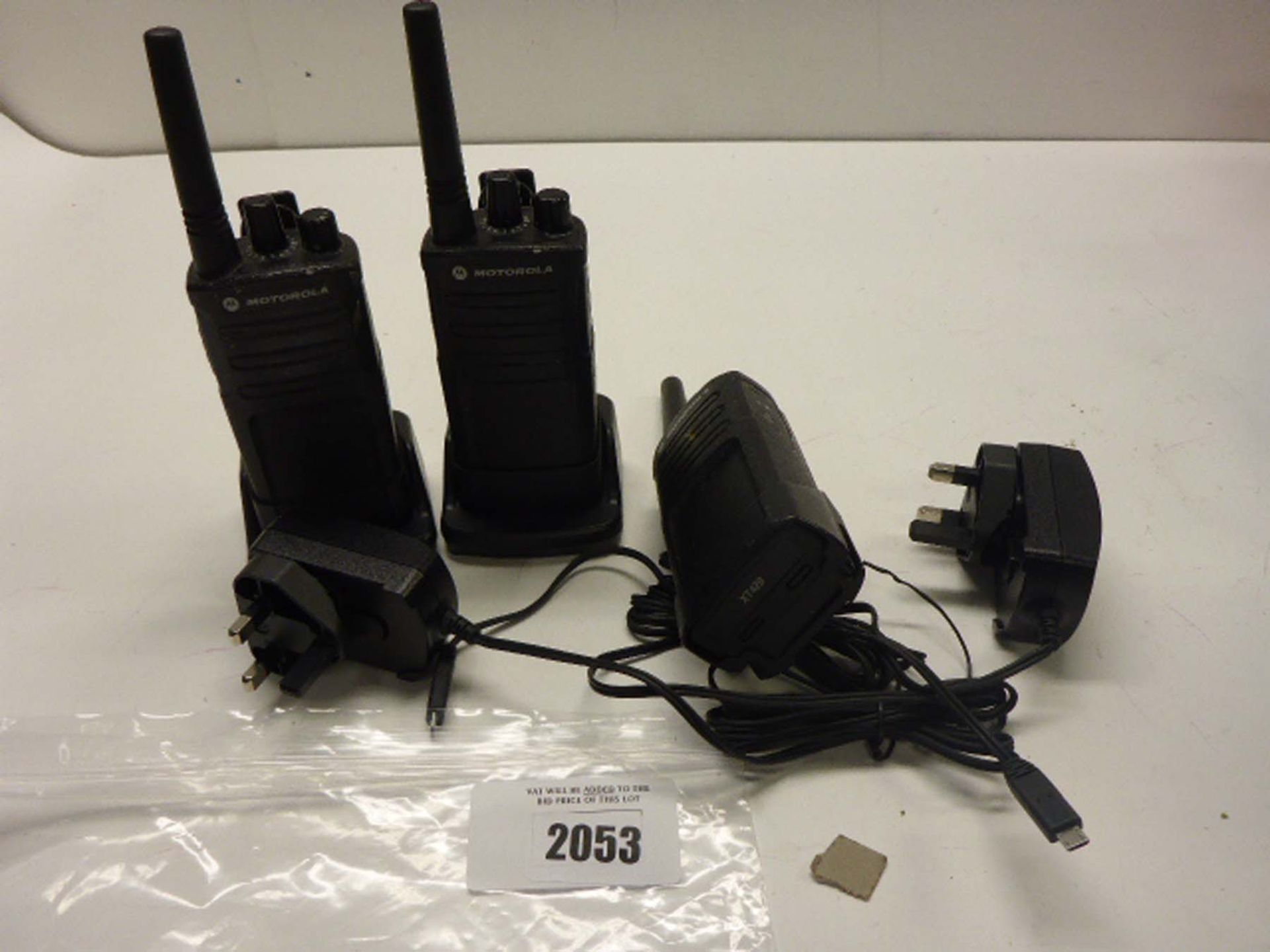 Three Motorola Radio Handsets with two power supplies and docks.