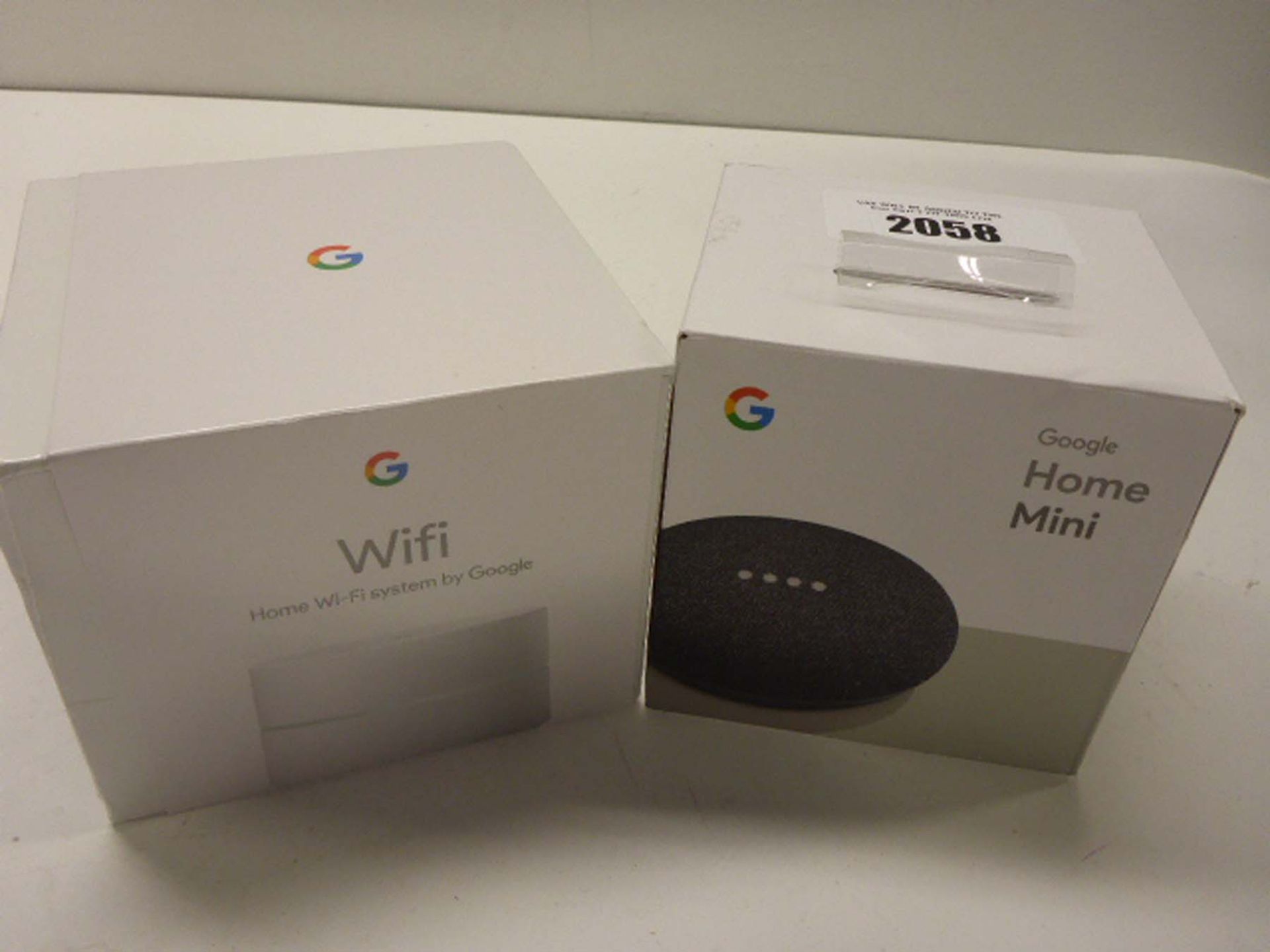 Google Home Mini and Google wifi unit in sealed box.