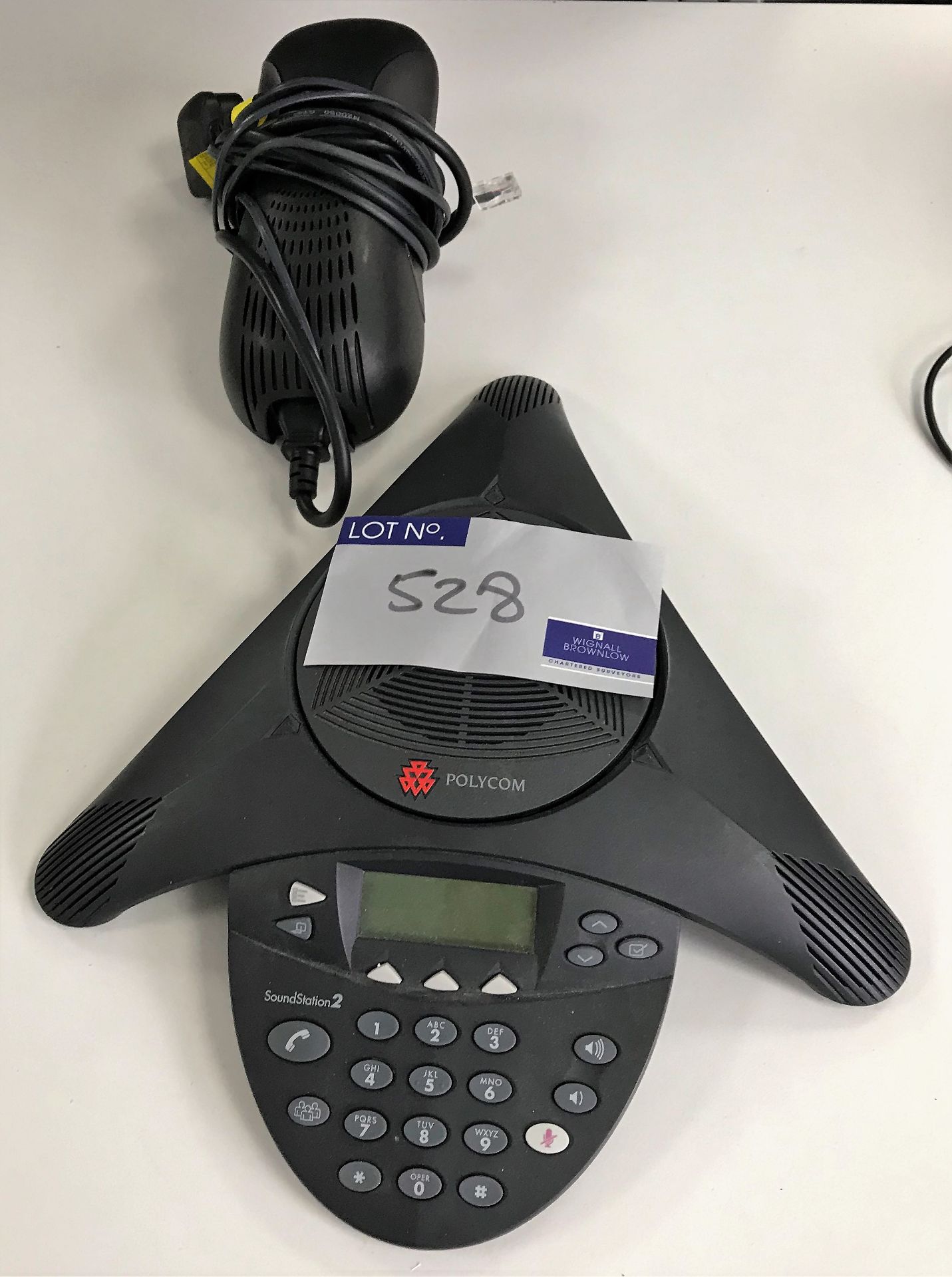A Polycom Soundstation 2 Conference Phone with Universal Power Supply Modules.
