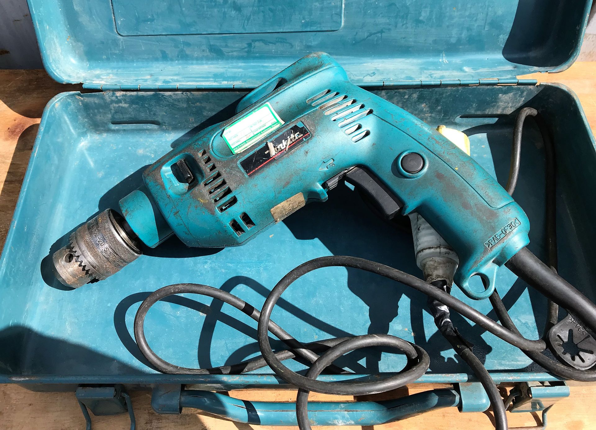 A Makita 8450 Electric Drill with case, 110v-locat