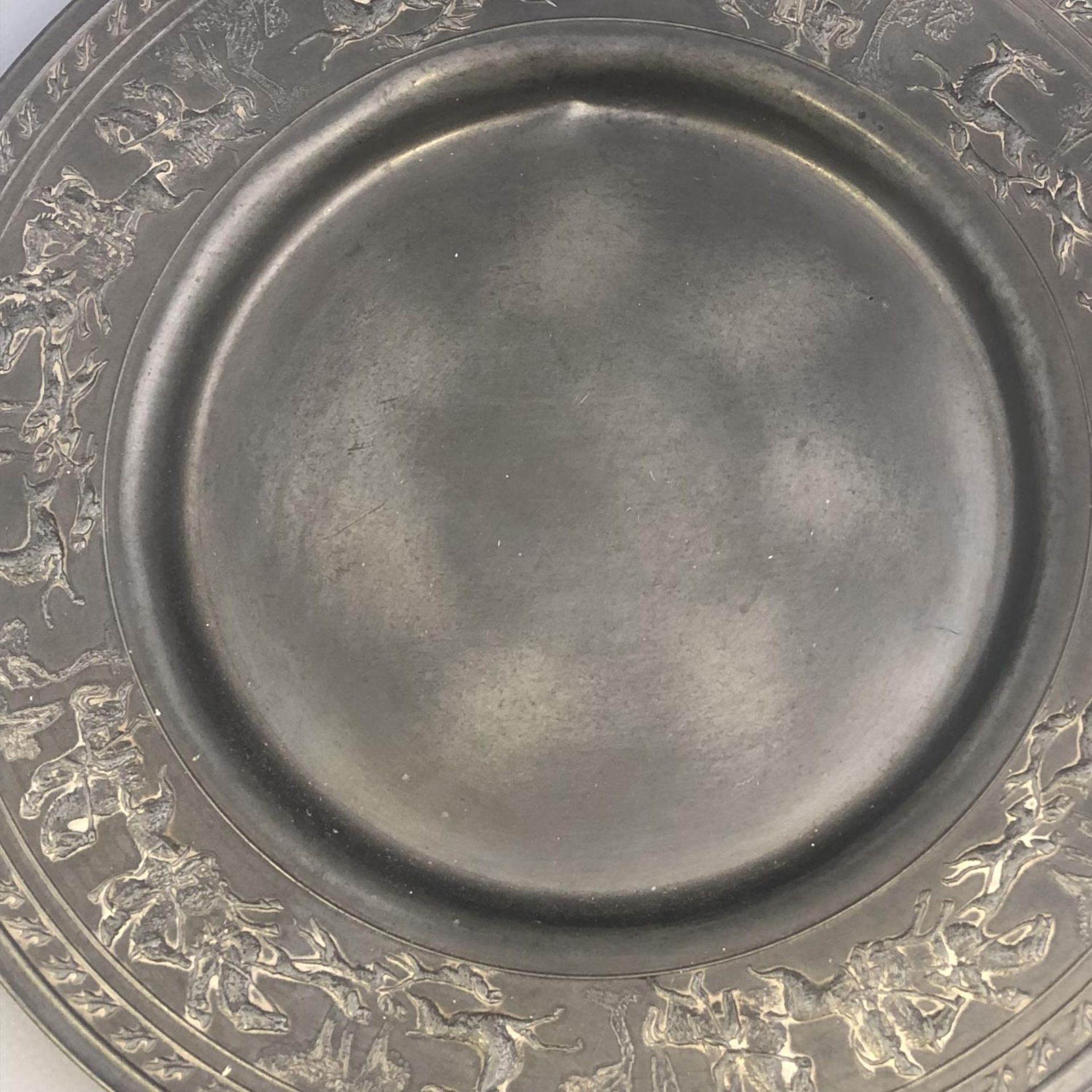 An antique German pewter plate with encircling Stag Hunting scene to border. Touchmarks to base. - Image 6 of 7