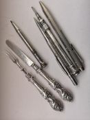 Group Of Pens And A Silver Knife And Fork