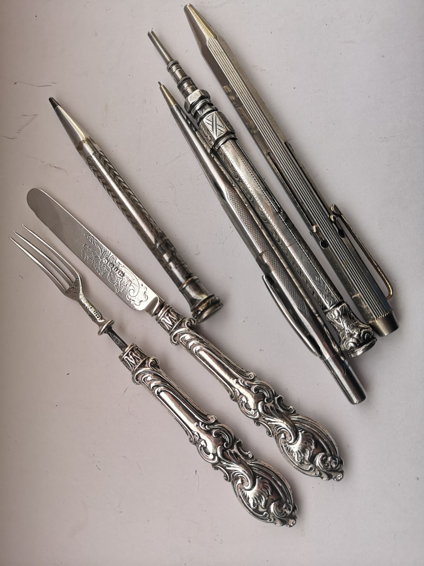 Group Of Pens And A Silver Knife And Fork