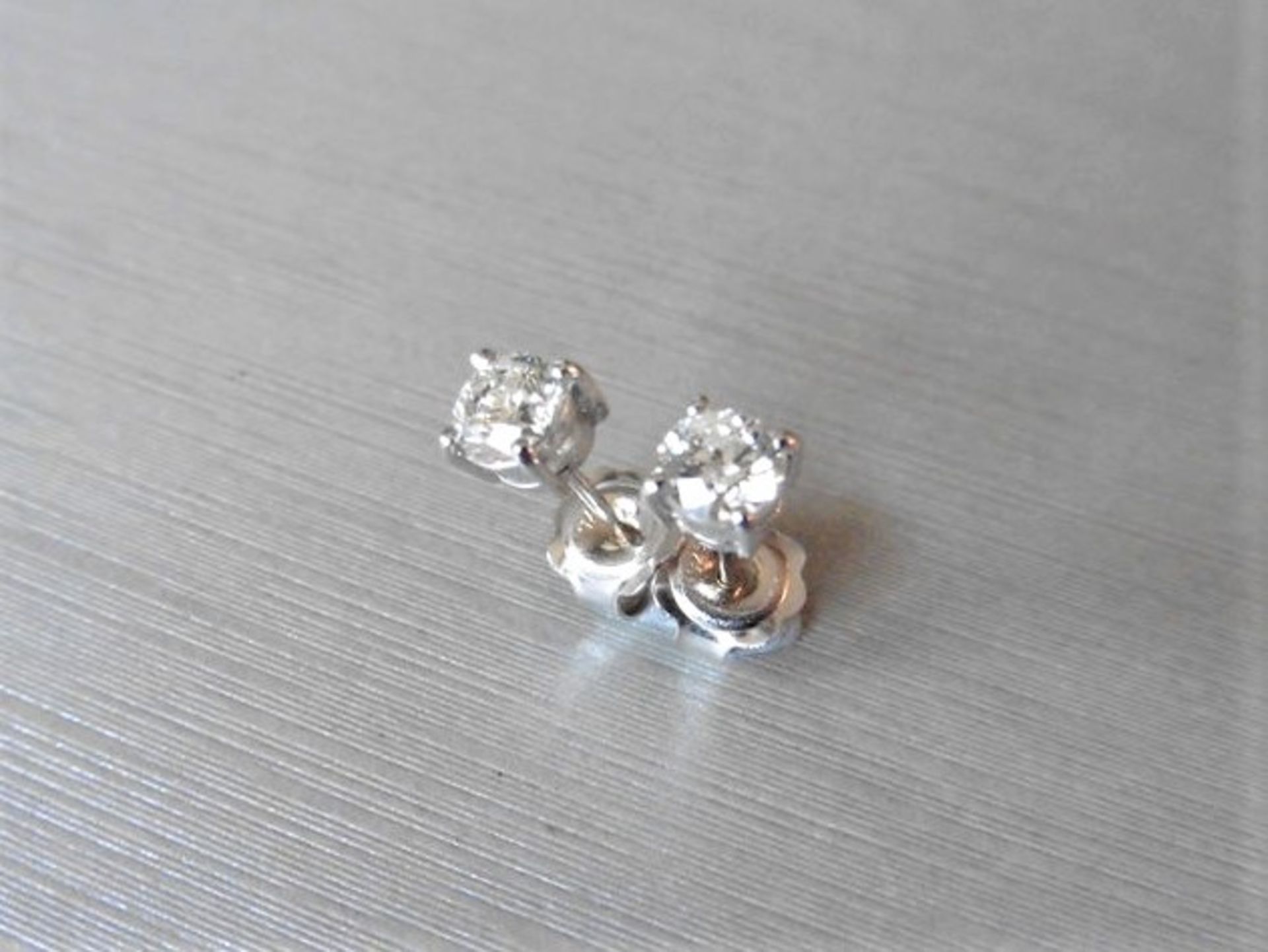 0.70ct diamond solitaire stud earrings set in platinum. I/J colour, si2 clarity.4 claw setting