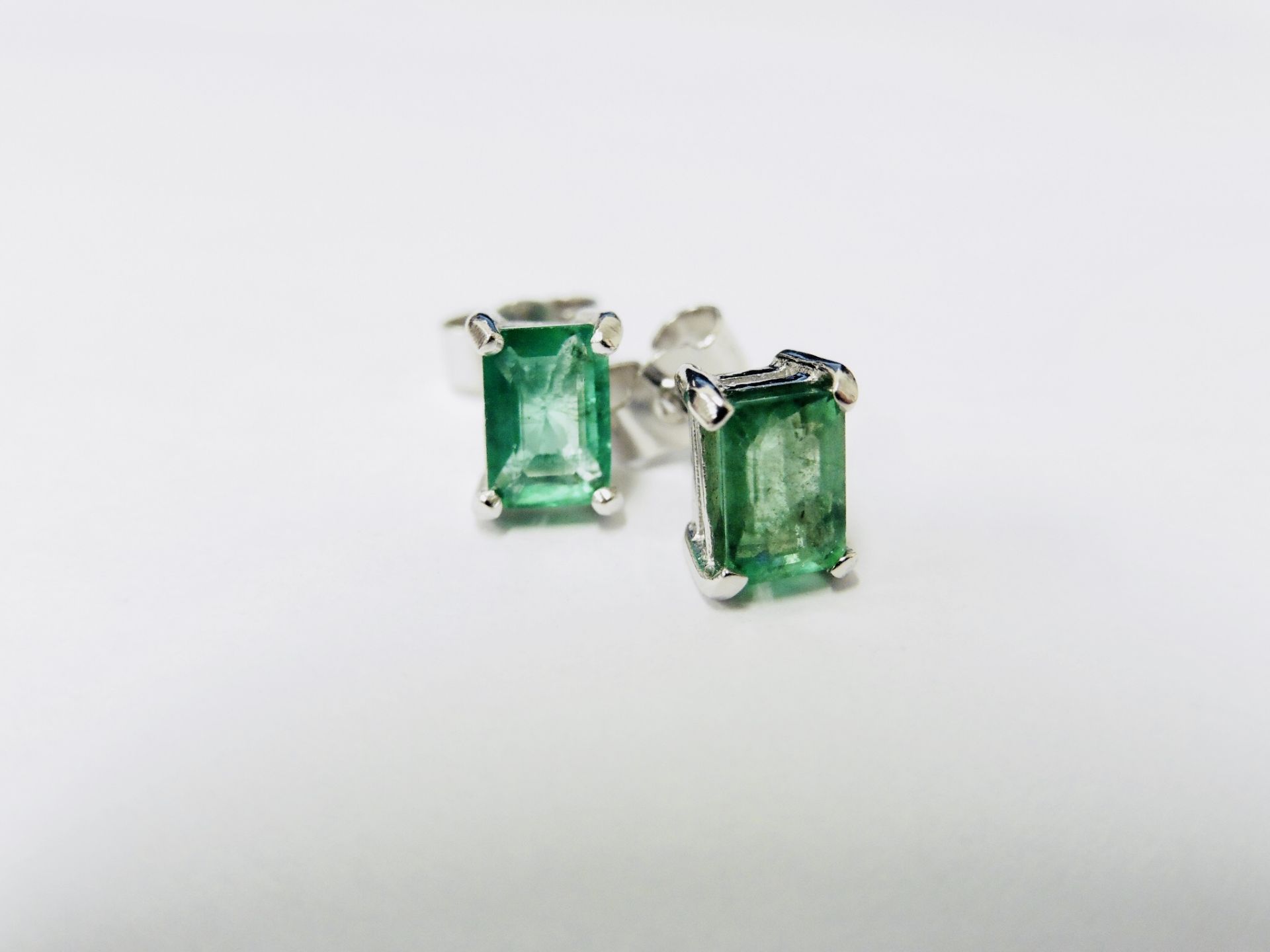 1.40ct stud earrings in platinum 950. 2 rectangular cut emeralds ( treated ) set in a simple 4