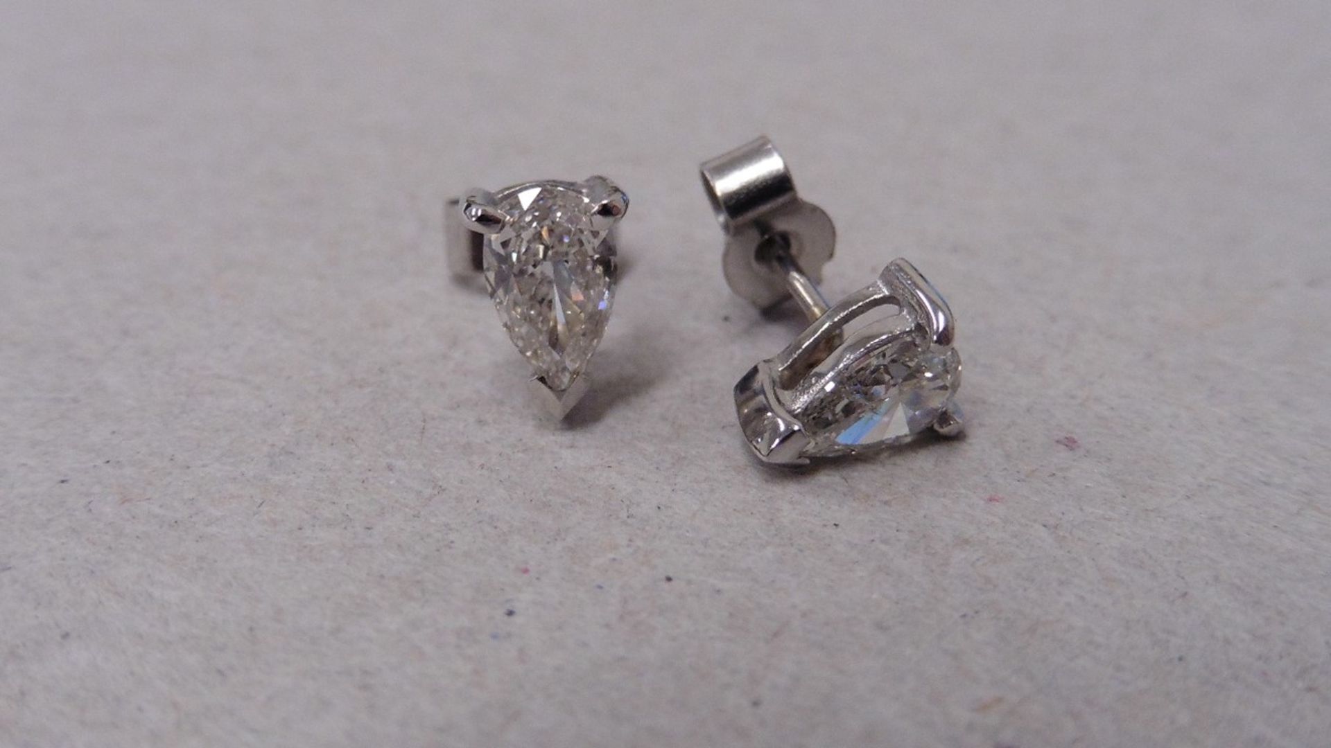 0.70ct diamond earrings set with pear shaped diamonds, I/J colour, si2 clarity. 3 claw setting in