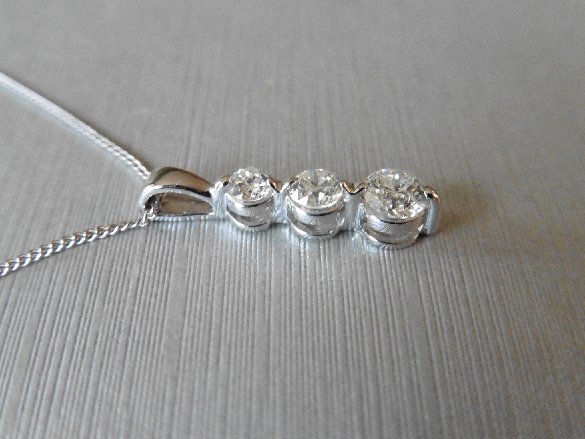 0.75ct Trilogy style pendant set with 3 graduated brilliant cut diamonds, I colour, Si2 clarity. Set