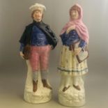Pair of late Staffordshire pottery figures, schoolboy and girl, gilded & painted