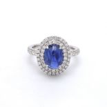 A Mesmerizing Blue Sapphire Diamond Ring Set In White Gold surrounded by sparkling Diamonds