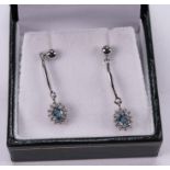 A pair of 9ct white gold diamond and blue topaz drop earrings