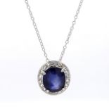 An Oval Shaped Sapphire and Diamond  Drop Pendant in Claw Setting
