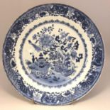 An 18th century Chinese blue and white plate with trees moths & precious objects