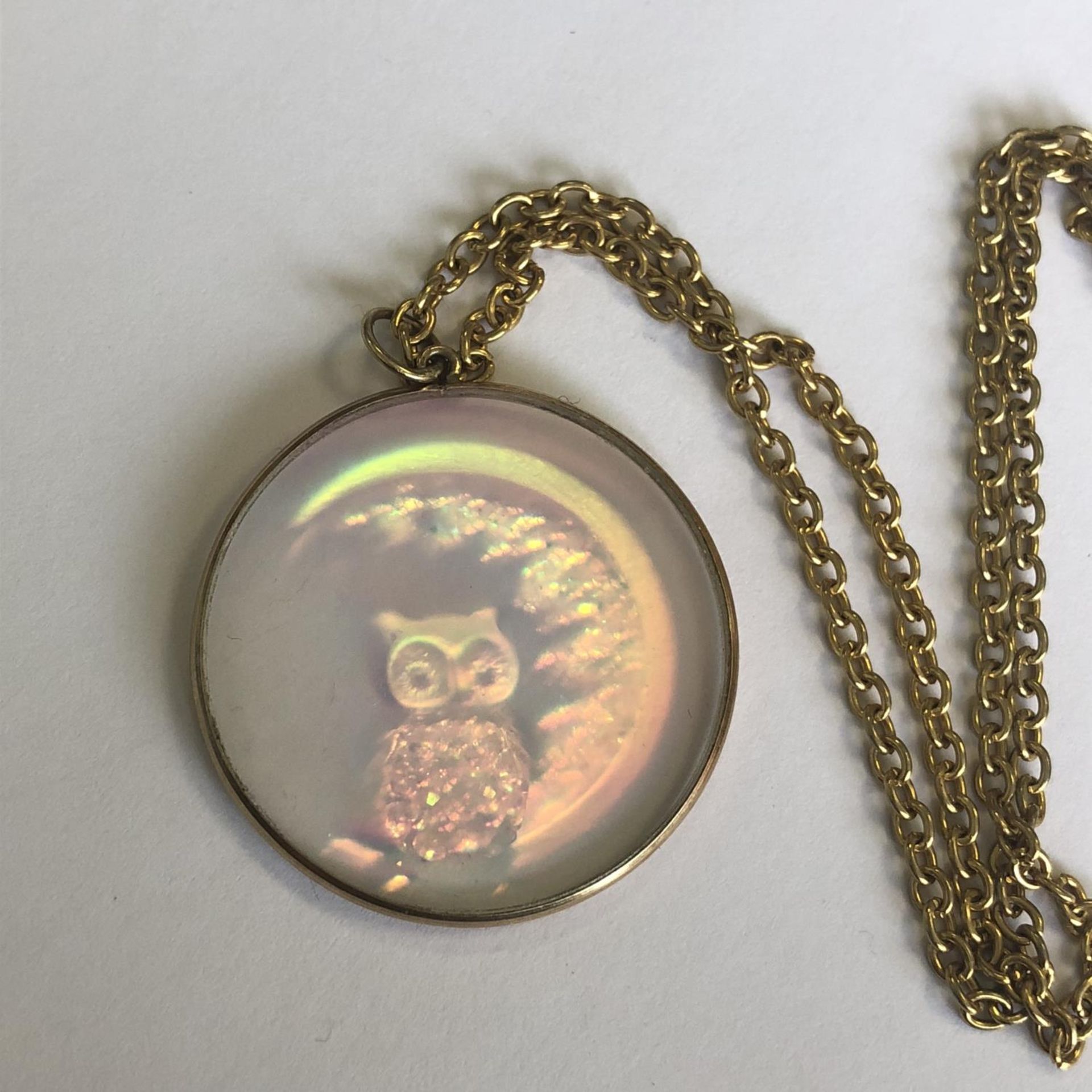 A vintage retro holographic owl pendant in yellow metal mount (untested) on a yellow metal chain