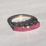 A vintage silver ring stamped 925 with 5 pink stones. UK size P