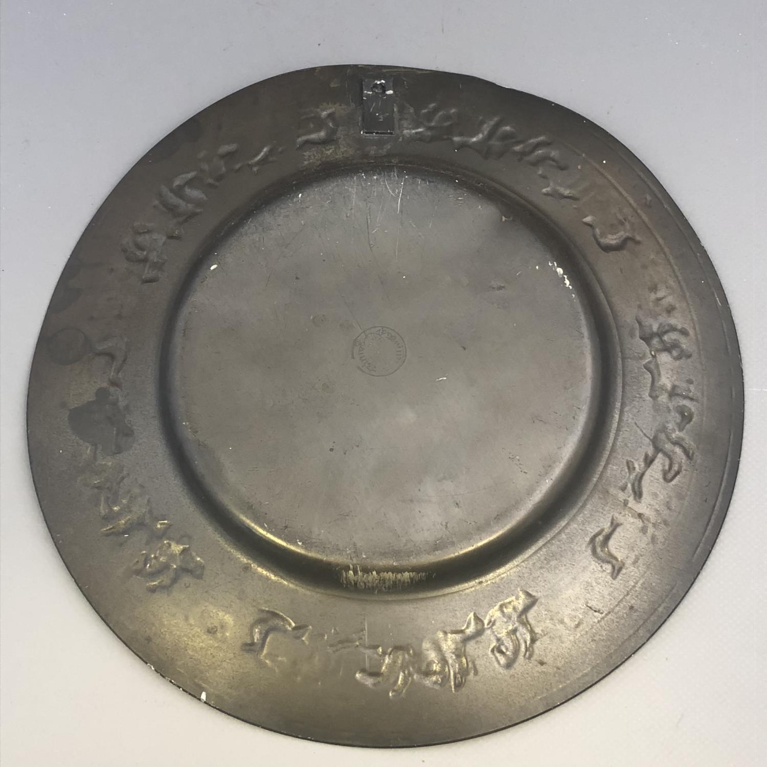 An antique German pewter plate with encircling Stag Hunting scene to border. Touchmarks to base. - Image 3 of 7