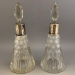 Pair of conical cut glass scent bottles with facet stoppers & white metal mounts