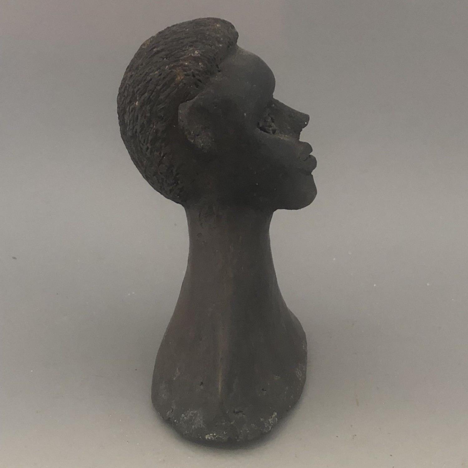 A carved clay pottery African figurine sculpture or candle snuffer