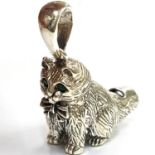 A modern silver (marked sterling) whistle pendant in the form of a cat with green stone eyes