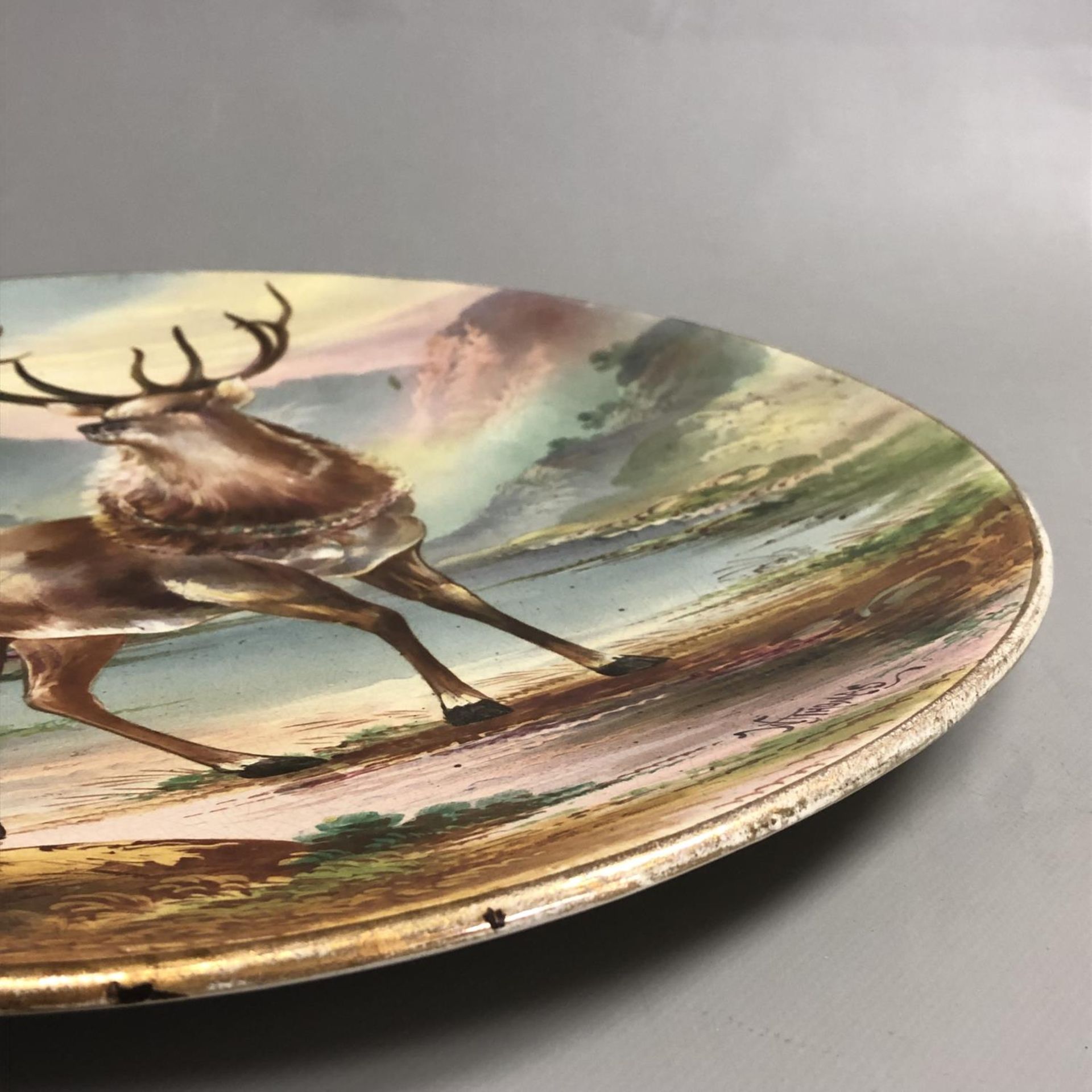 A large antique circular pottery plaque with hand painted scene of a Highland Stag. Signed W Thomas. - Image 5 of 7