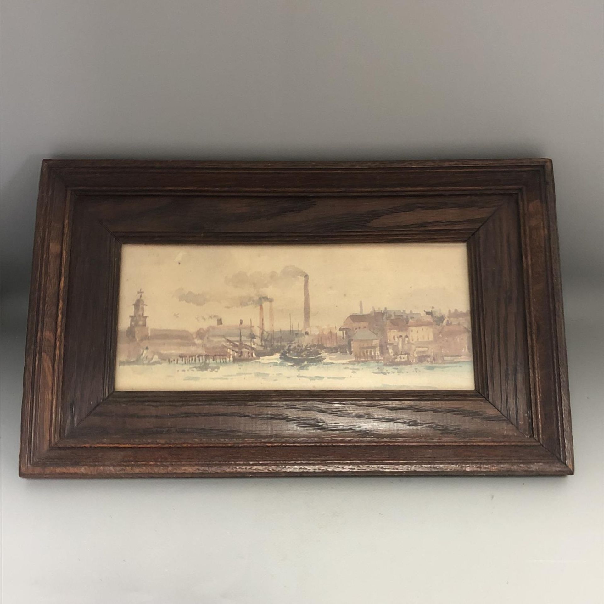 A small oak framed watercolour of a harbour town. Labelled verso - Painted by Lady Egerton