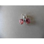 9ctct white gold tourmaline and diamond hoop style earrings. 2 oval cut tourmalines, 1.60ct total