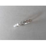 0.42ct diamond band ring set in 9ct white gold. 7 Small brilliant cut diamonds, I colour and i1