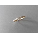 0.32ct diamond band ring set in 9ct yellow gold. Small brilliant cut diamonds, I colour and i1