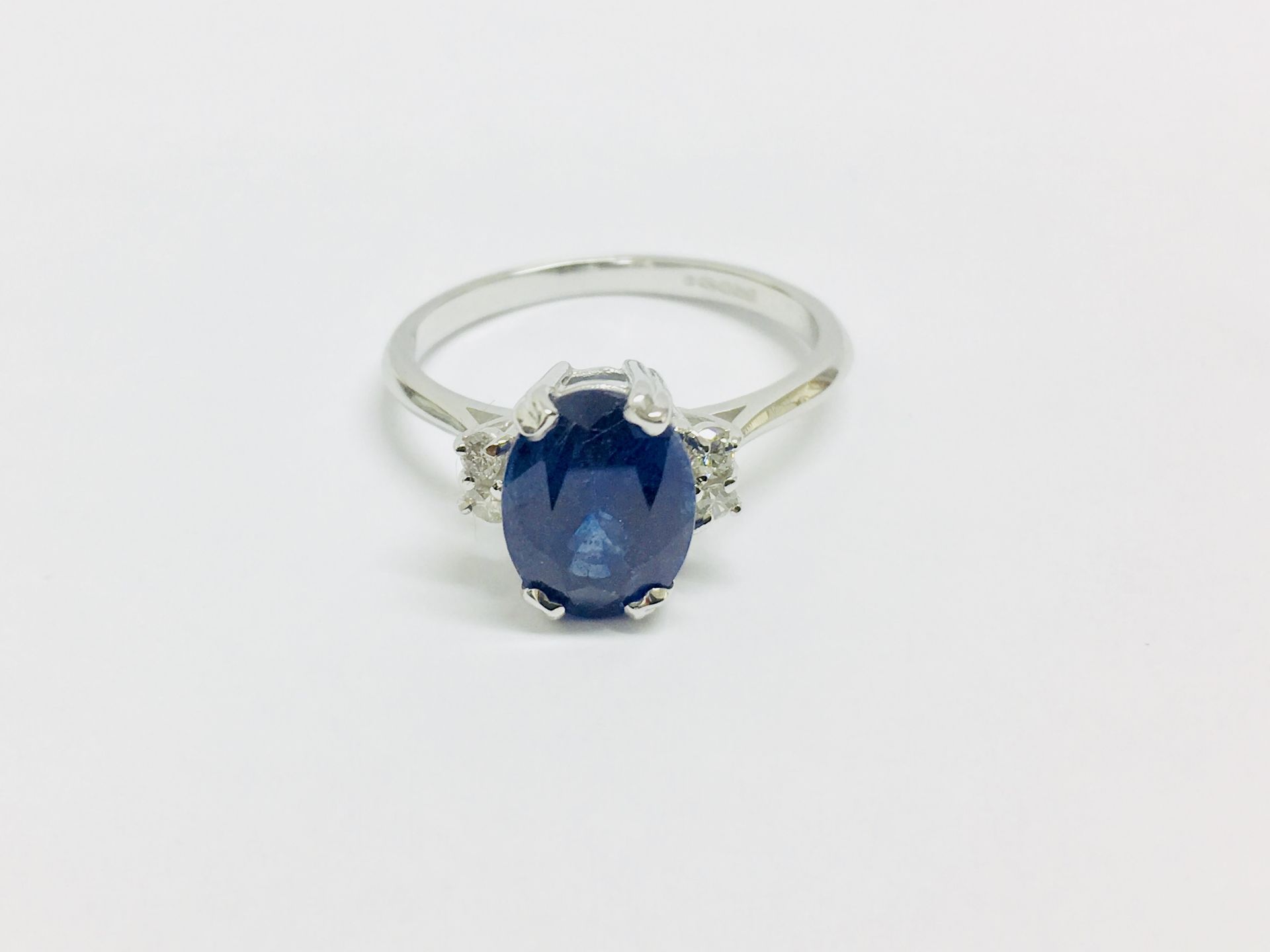 2.40ct sapphire and diamond ring. Oval cut ( glass filled ) sapphire with 2 small brilliant cut - Image 2 of 3