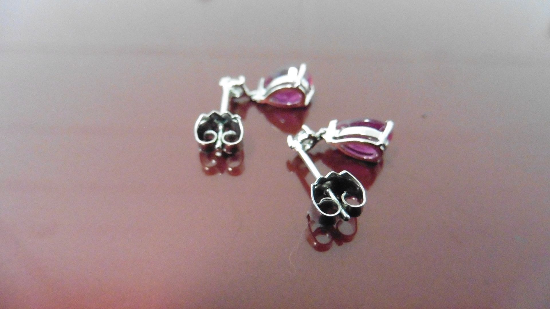 0.70ct drop style earrings. Each set with a pear shaped ruby ( glass filled ) and a small - Image 2 of 3