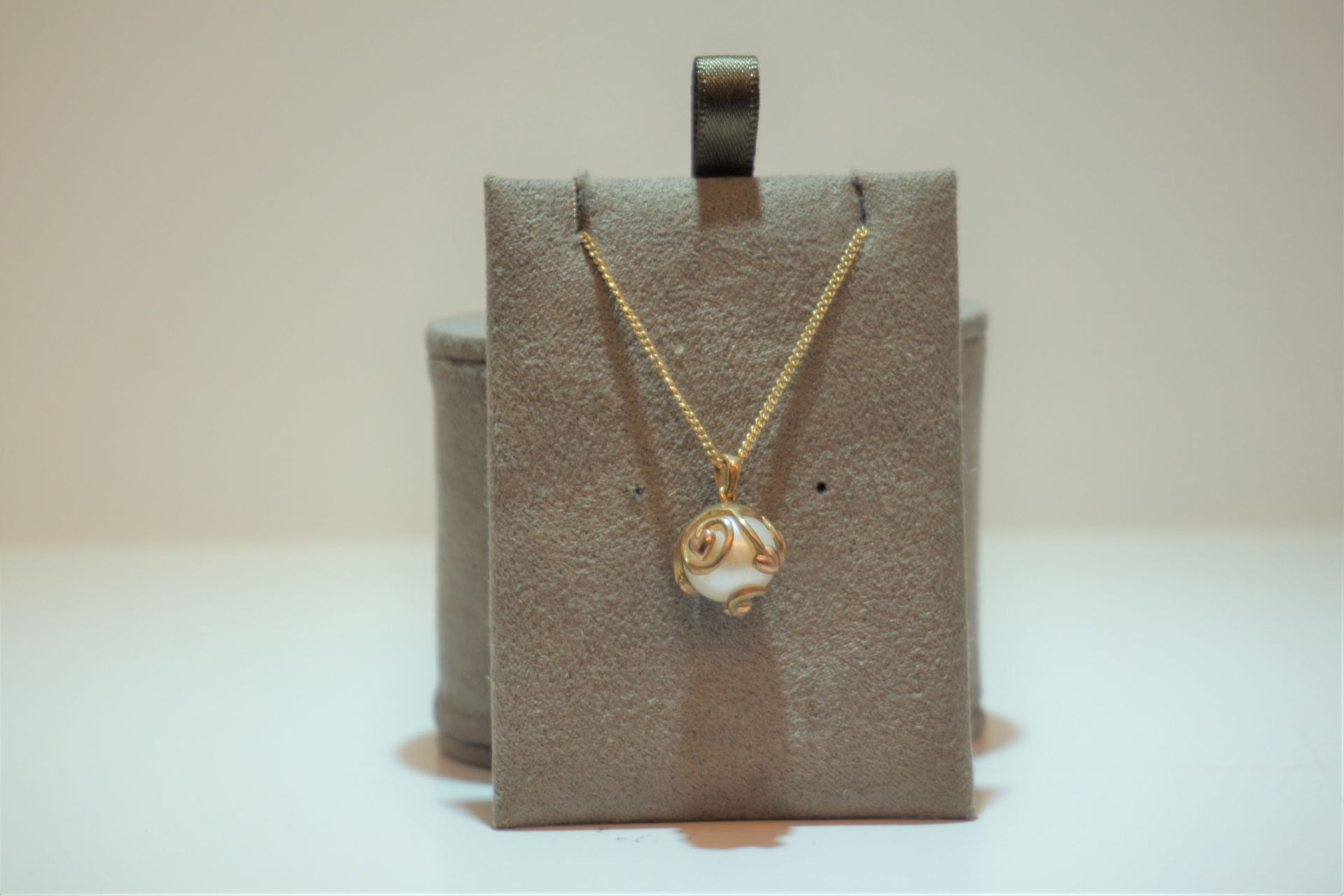 Gold chain and pearl pendant