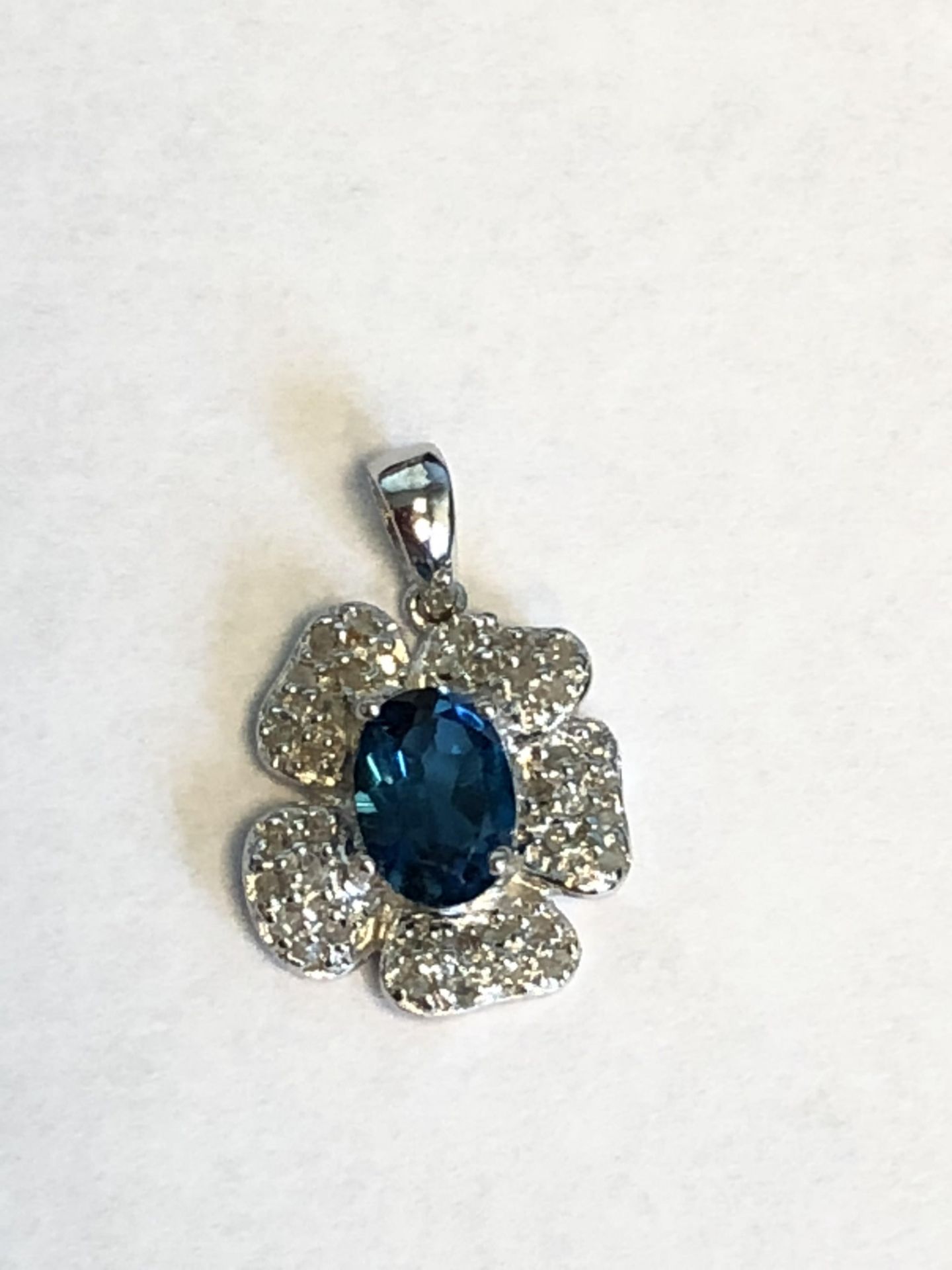 Platinum over sterling silver Blue Topaz and Diamond Pendant