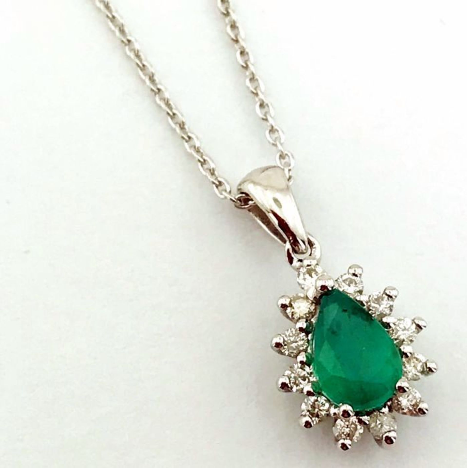 14K White Gold Cluster Pendant set with a natural emerald and 12 brilliant cut diamonds