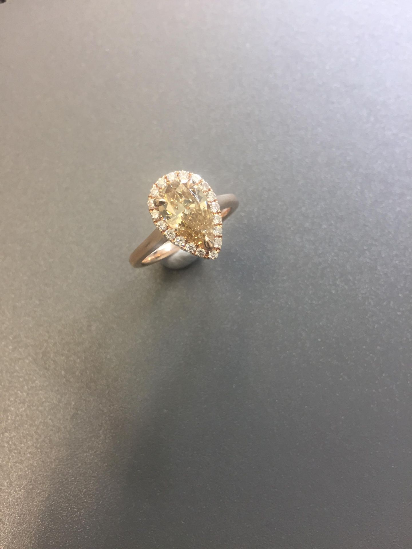 1.47ct pear shaped diamond set ring. Fancy yellow pear diamond, I1 clarity. Set in 18ct rose gold.