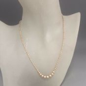 An antique delicate dainty faux pearl necklace graduated pearls - silver clasp