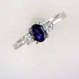 Sapphire & Trilogy Diamond Ring. Set With A Central Oval Sapphire & Two Brilliant Round Cut Diamonds