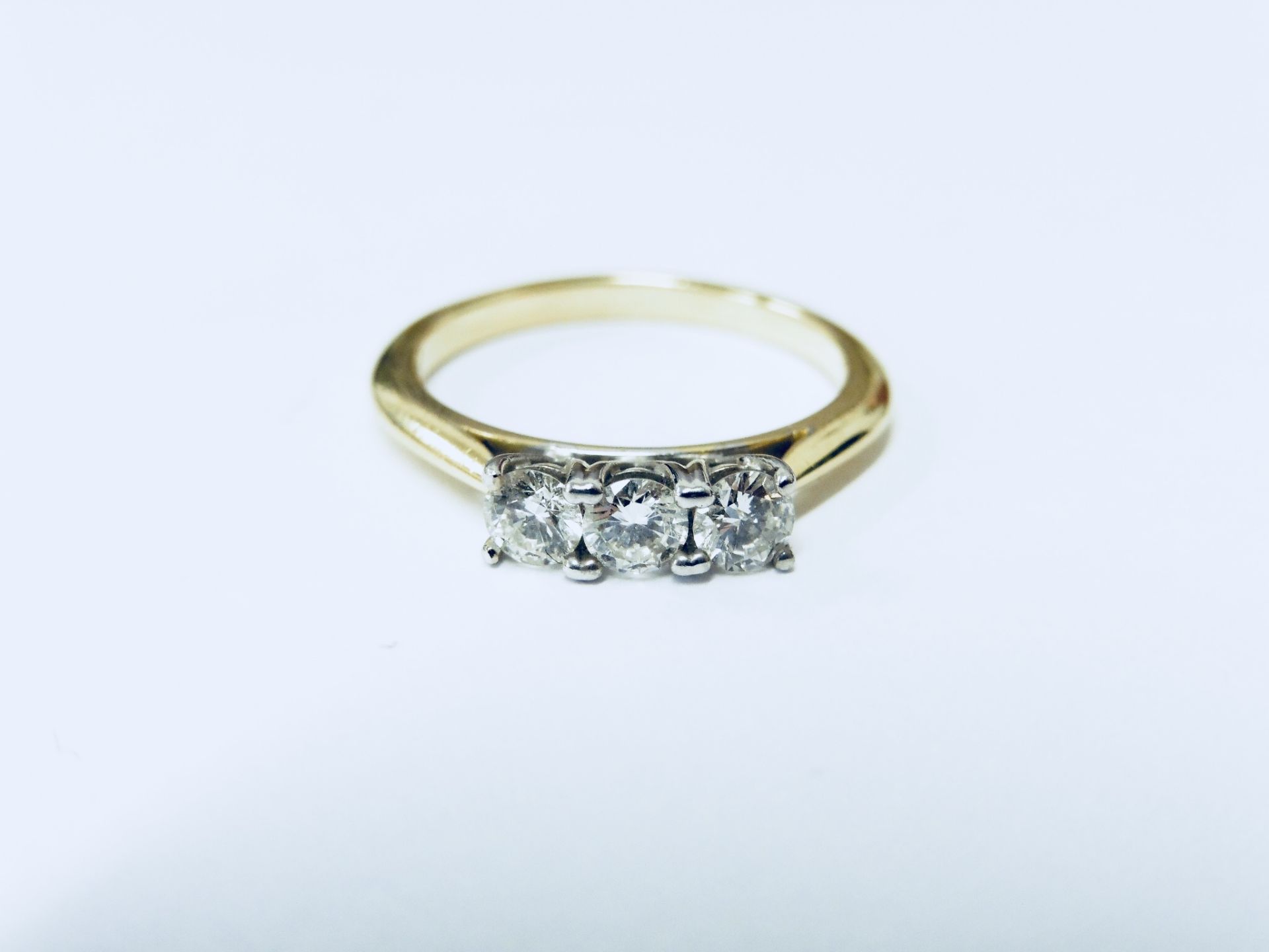 0.60ct diamond trilogy ring set in 18ct gold. Brilliant cut diamonds, I/J colour and Si3 clarity.