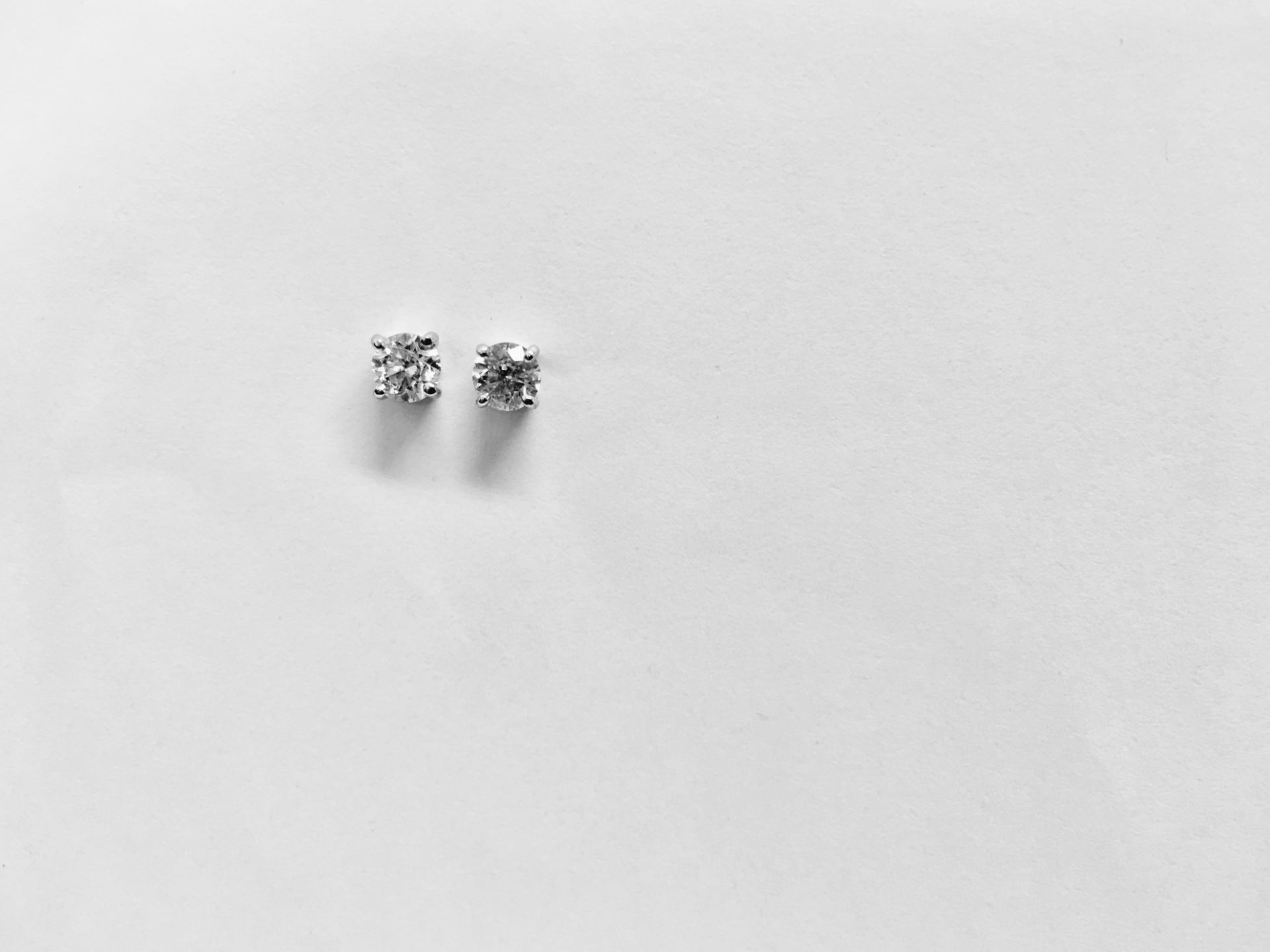 0.15ct Solitaire diamond stud earrings set with brilliant cut diamonds, i1 clarity and I colour. Set