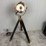 This Floor Lamp is a repurposed Francis searchlight on a wooden tripod.