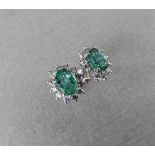 1.60CT EMERALD AND DIAMOND CLUSTER STYLE STUD EARRINGS.
