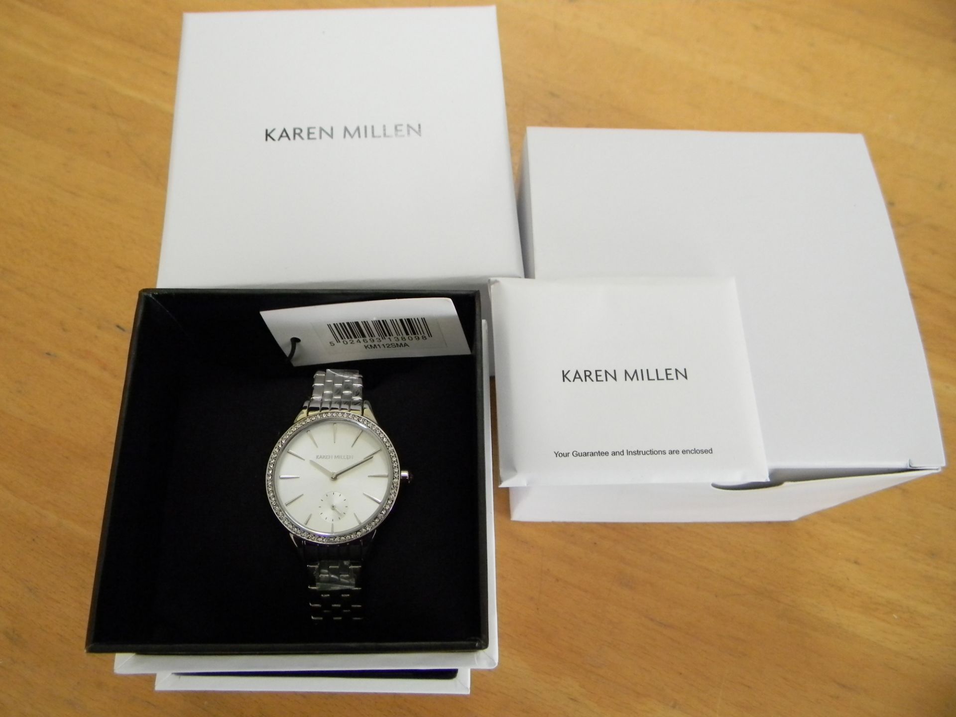 Karen Millen Ladies  Analogue Quartz Watch with White Dial and Silver Stainless Steel Strap.