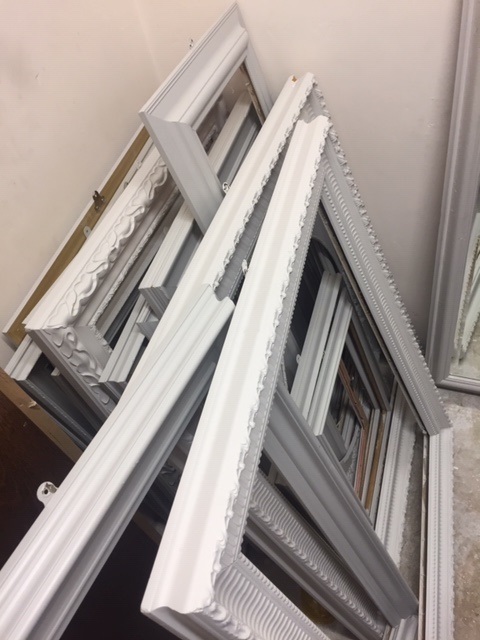 A bundle of various sized picture frames painted grey