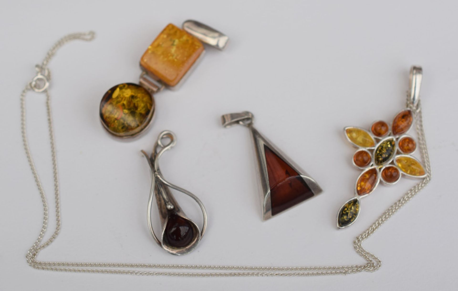 Four Silver And Amber Pendants One On A Silver Chain