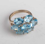 Damenring, Gelbgold 375, der Ringkopf ausgefasst mit 7 oval-facettierten, blauenFarbedelsteinen,