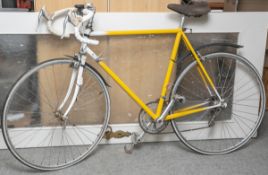 Gelb-weißes Rennrad (wohl 1970er Jahre), ohne Herstellerbezeichnung, mit Tacho (