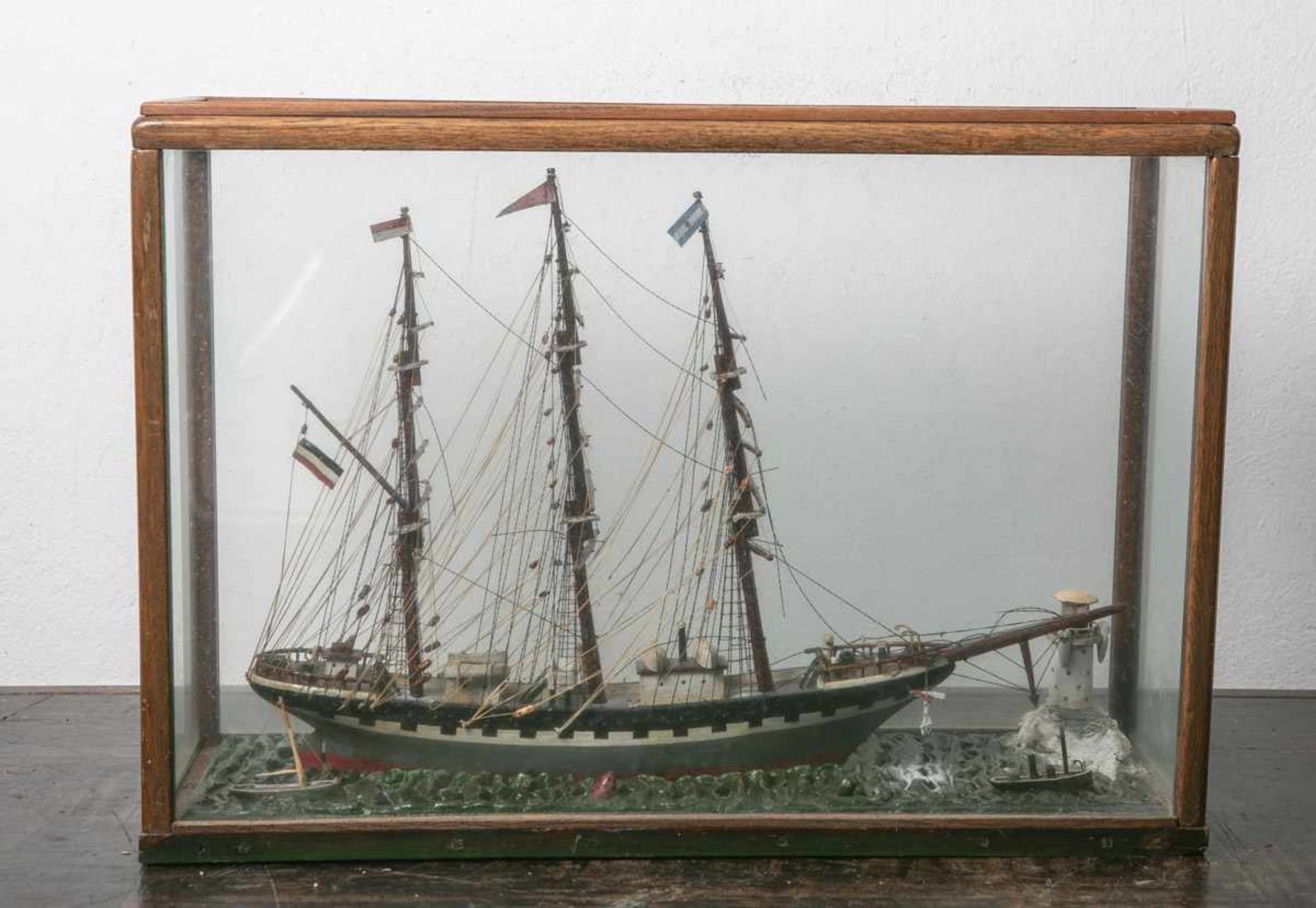 Segelschiffmodell im Glaskasten (wohl 20. Jahrhundert), aus Holz, polychrom bemalt, mitLeuchtturm,