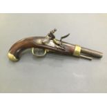 An early 19th Century French flintlock service pistol, with walnut stock and brass mounts.